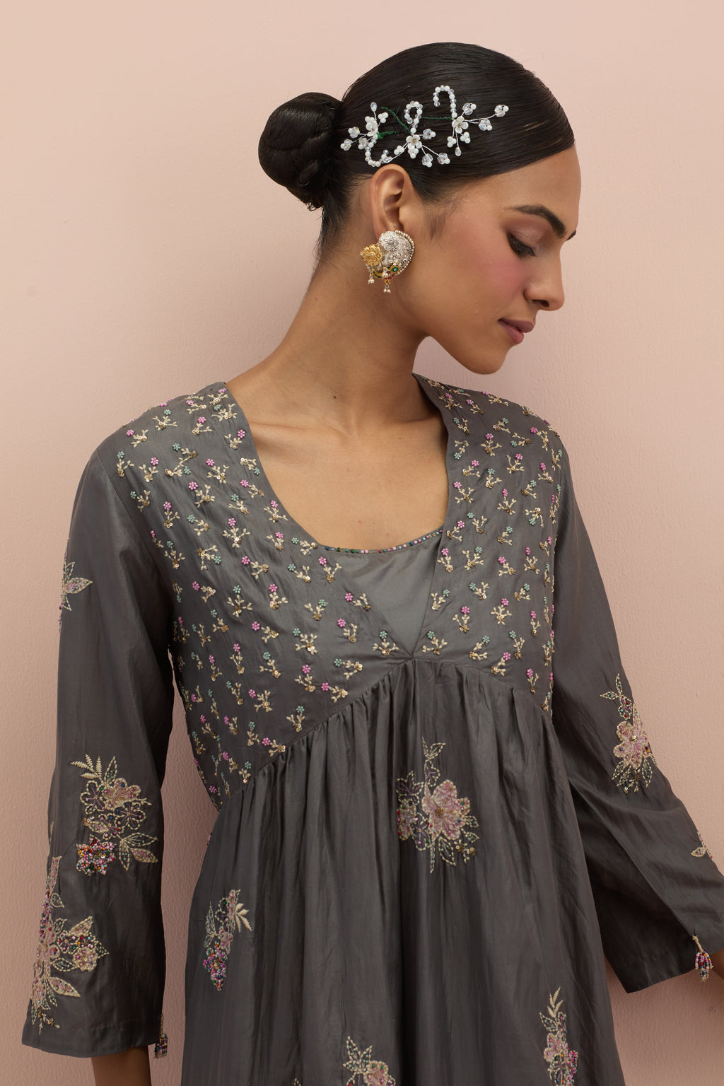 Iron grey silk kurta dress set with delicate embroidered flowers and hand block printed appliqué motifs, highlighted with sequins and multi-colored beads.