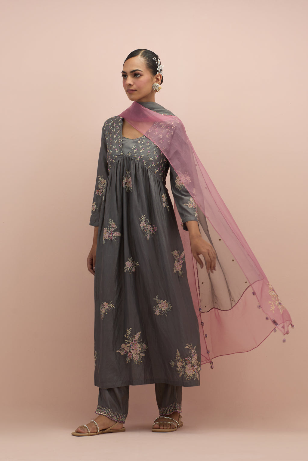 Iron grey silk kurta dress set with delicate embroidered flowers and hand block printed appliqué motifs, highlighted with sequins and multi-colored beads.