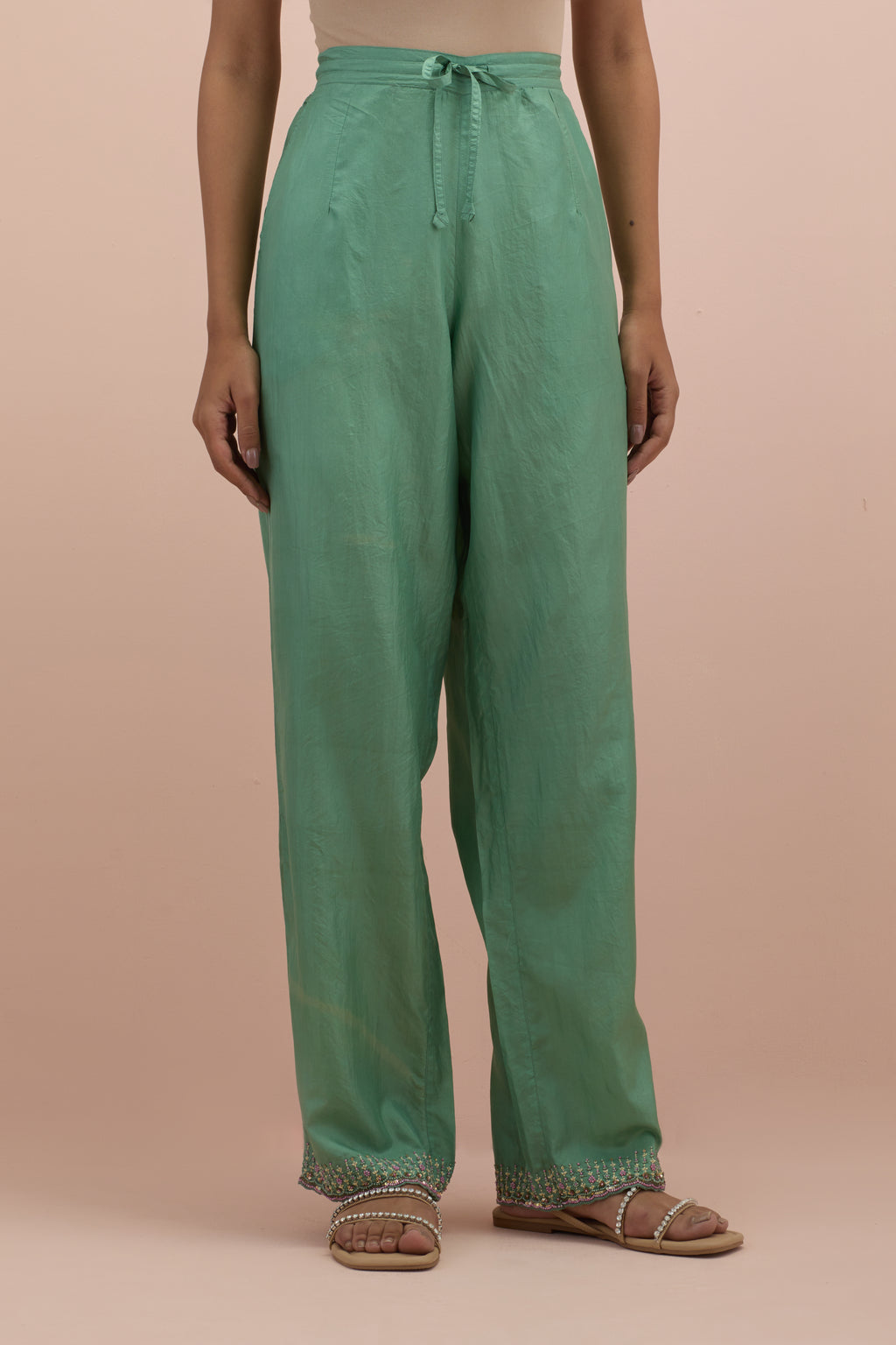 Jade green silk straight pants with sequins and multi-colored beadwork at hem.