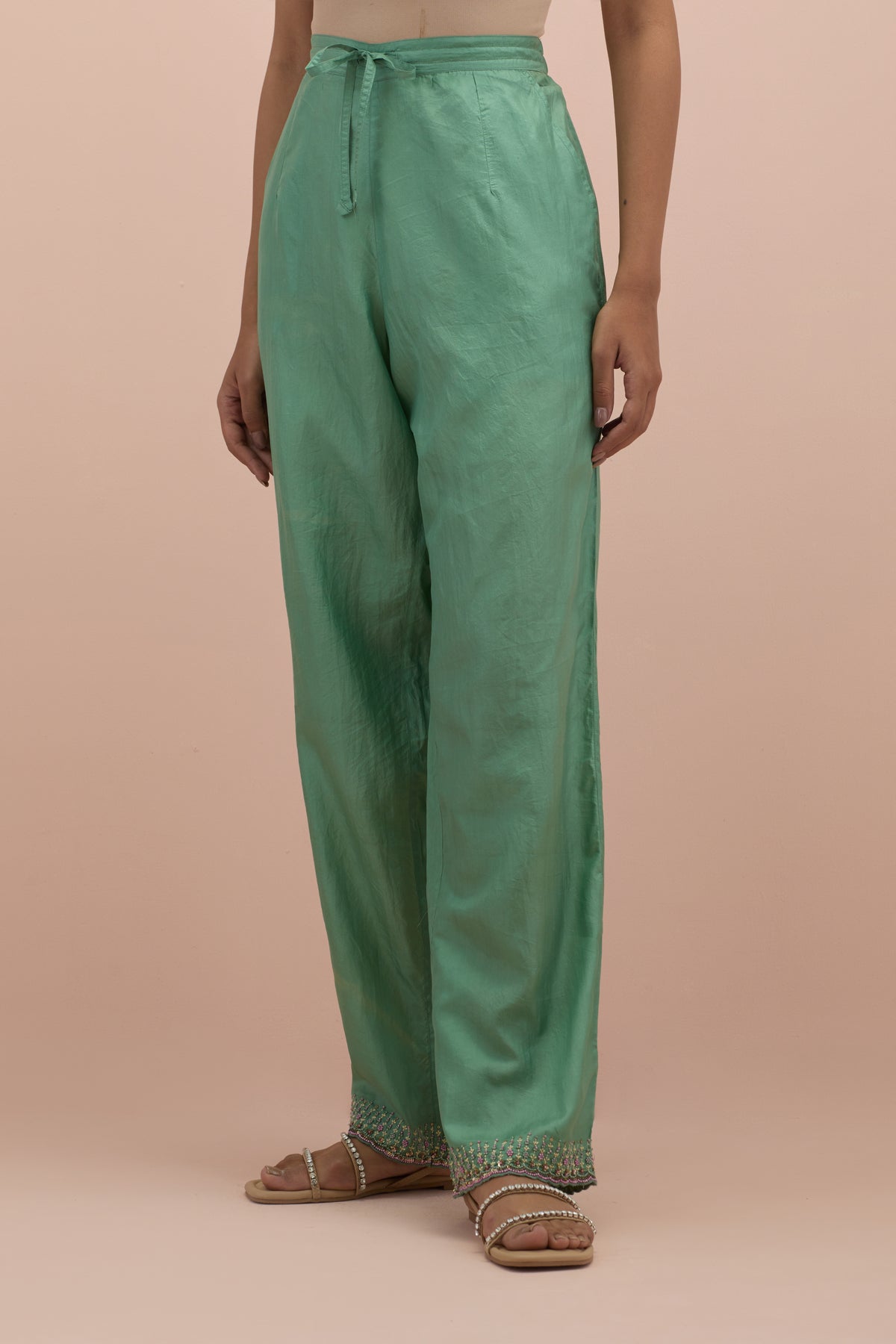 Jade green silk straight pants with sequins and multi-colored beadwork at hem.
