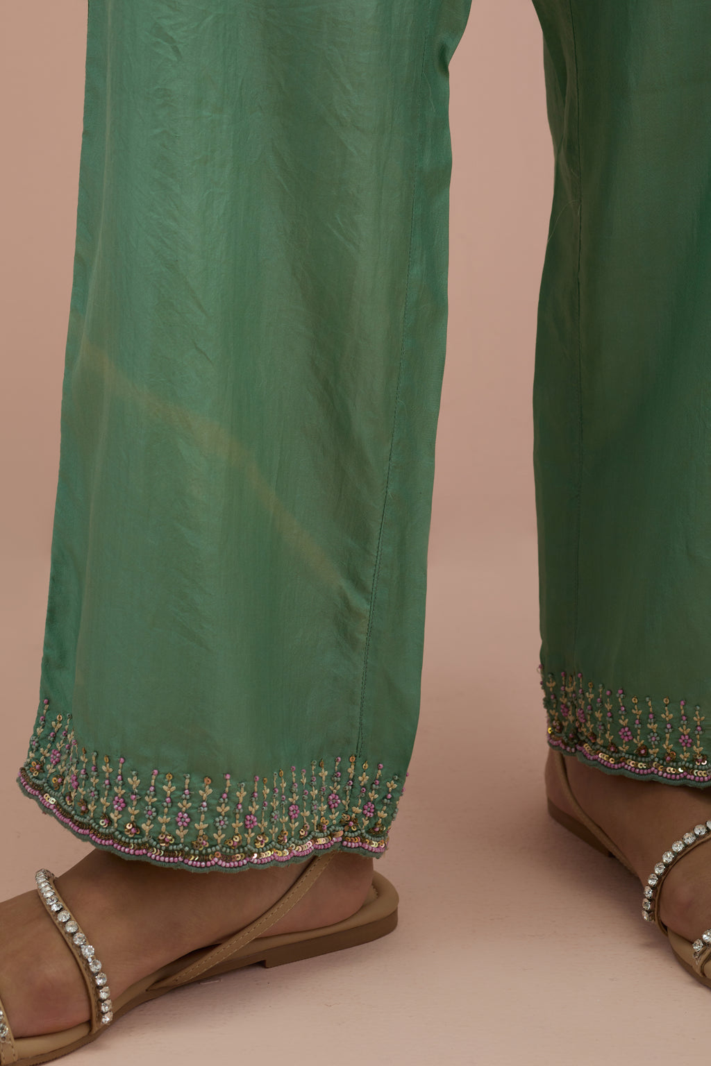 Jade green silk straight pants with sequins and multi-colored beadwork at hem.