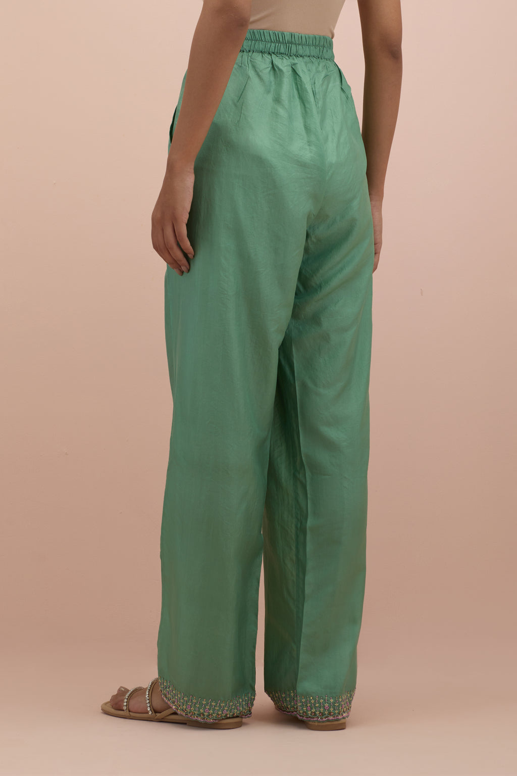 Jade green silk straight pants with sequins and multi-colored beadwork at hem.