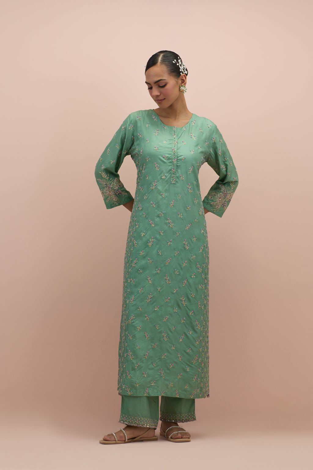 Jade green straight kurta set with all-over delicate embroidered flowers, highlighted with sequins and multi-colored beads.