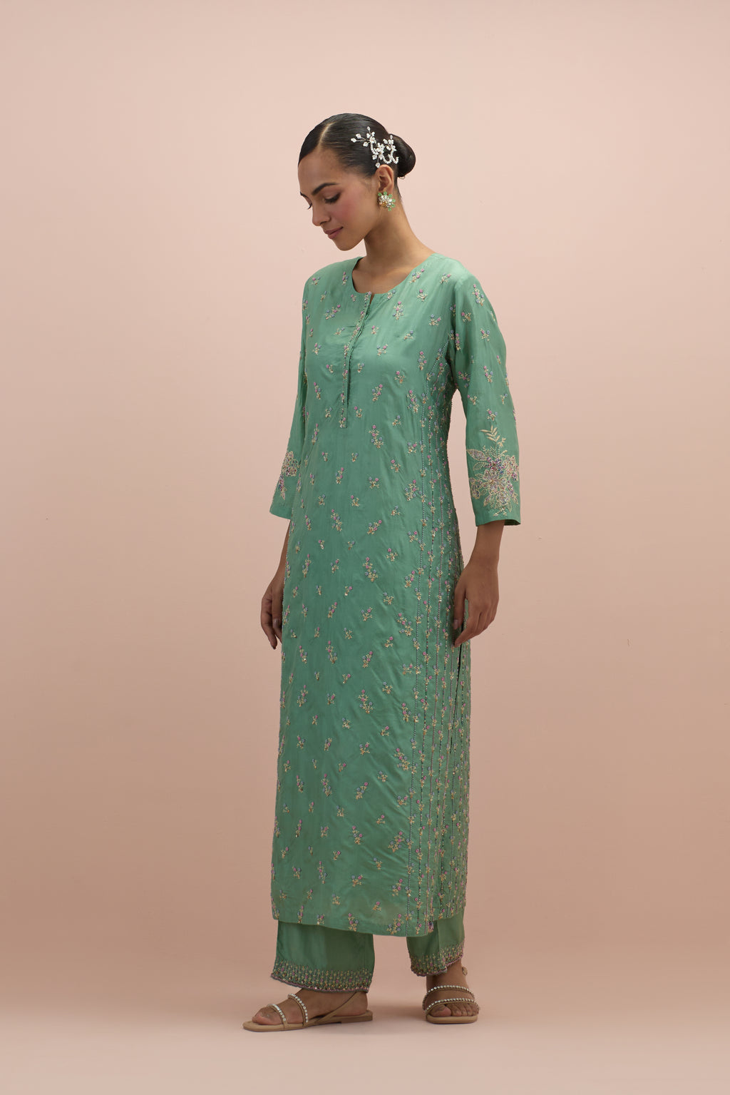 Jade green straight kurta set with all-over delicate embroidered flowers, highlighted with sequins and multi-colored beads.