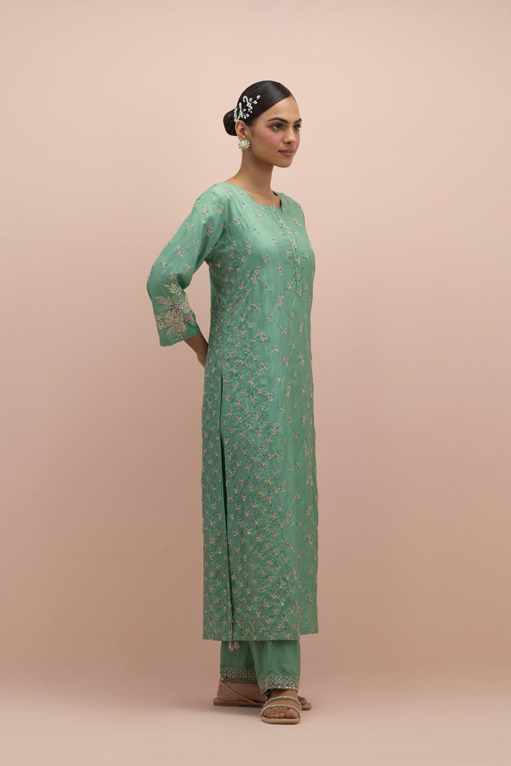Jade green straight kurta set with all-over delicate embroidered flowers, highlighted with sequins and multi-colored beads.