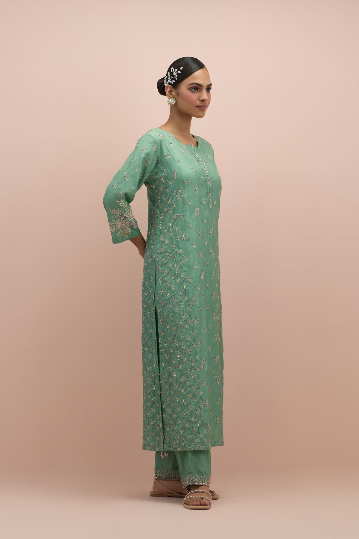 Jade green straight kurta set with all-over delicate embroidered flowers, highlighted with sequins and multi-colored beads.