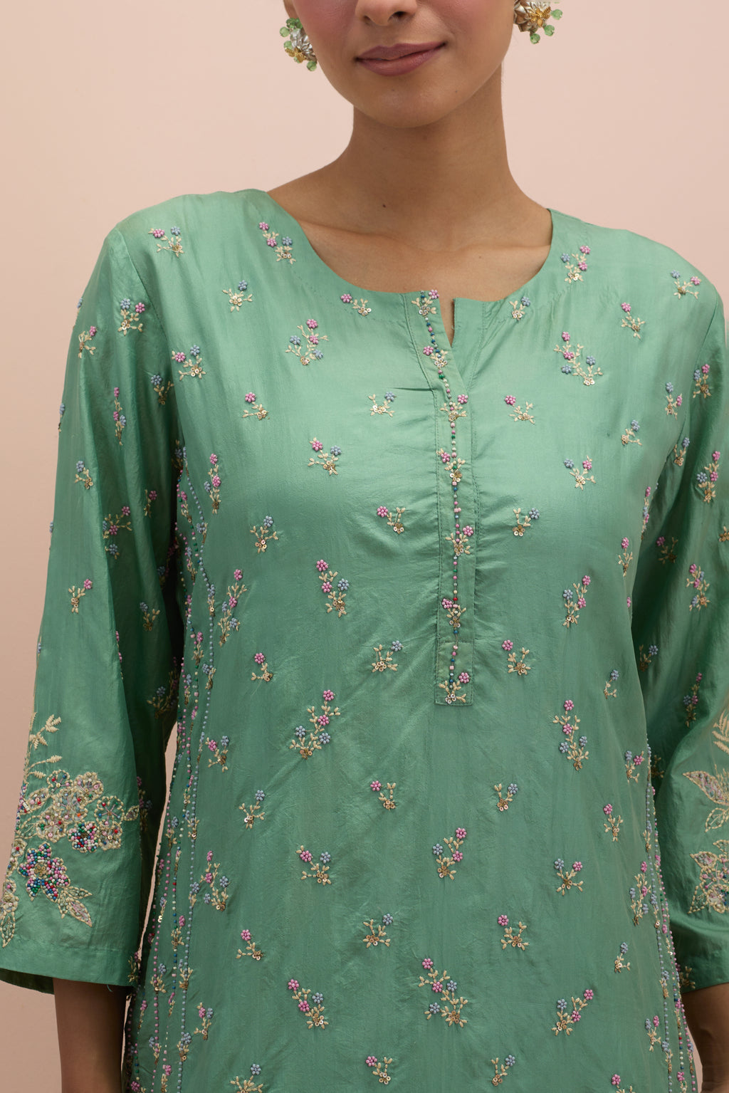 Jade green straight kurta set with all-over delicate embroidered flowers, highlighted with sequins and multi-colored beads.