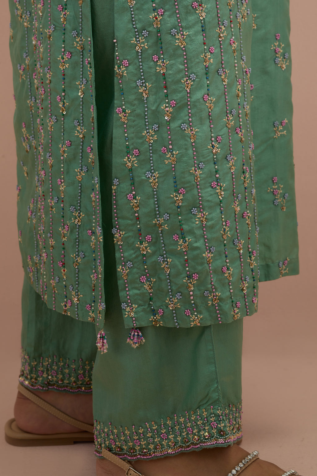 Jade green straight kurta set with all-over delicate embroidered flowers, highlighted with sequins and multi-colored beads.