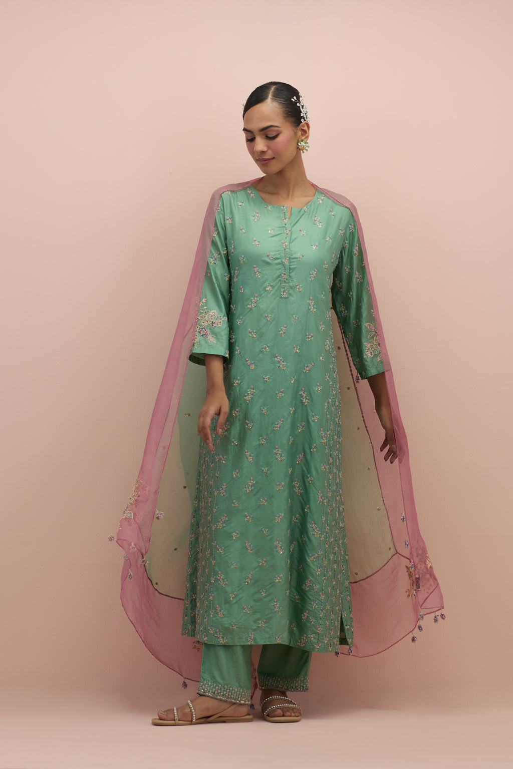 Jade green straight kurta set with all-over delicate embroidered flowers, highlighted with sequins and multi-colored beads.