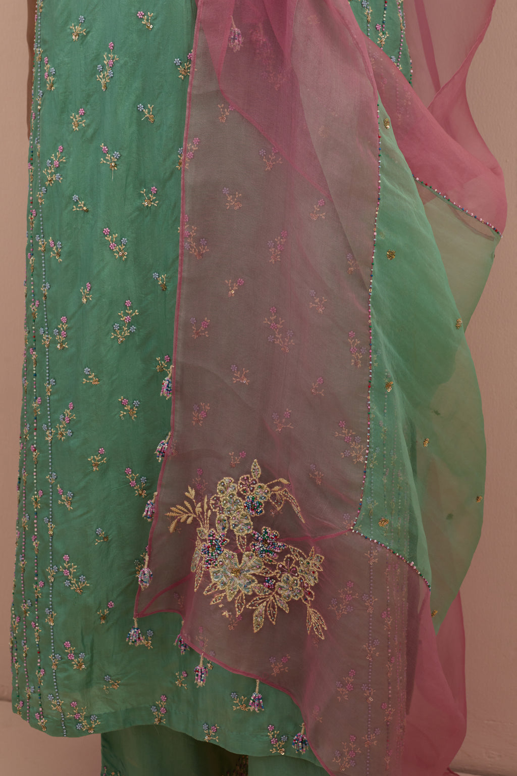 Jade green & salmon pink silk organza narrow dupatta, highlighted with all-over delicate sequins flower and hand block printed appliqué motifs at dupatta corners.