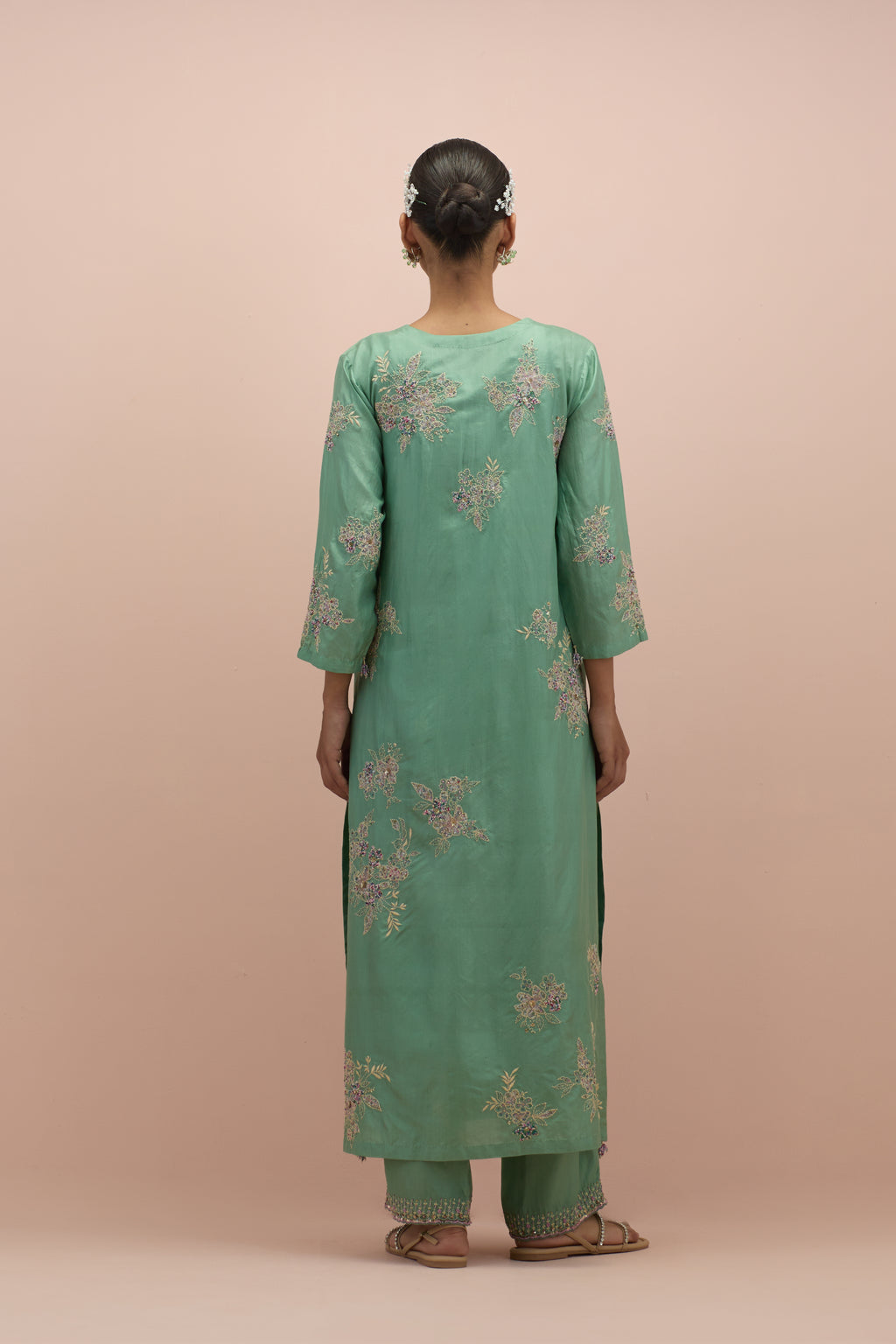 jade green silk straight kurta set with randomly placed hand block printed appliquéd flowers, highlighted with sequins and multi-colored beads.