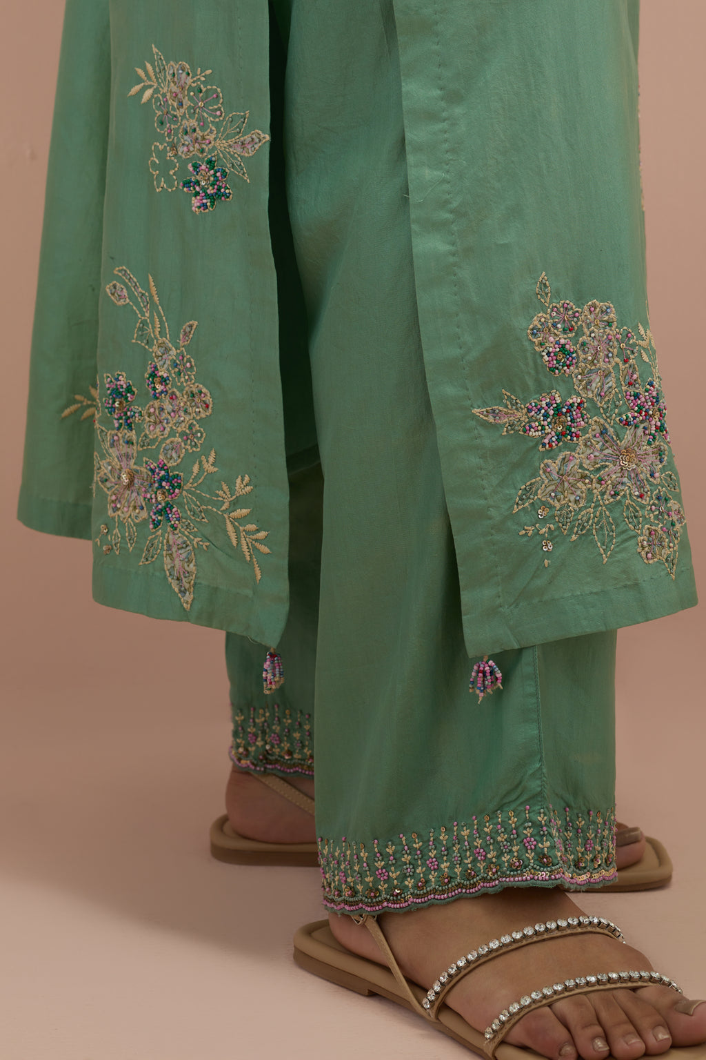 Jade green straight kurta set with all-over delicate embroidered flowers, highlighted with sequins and multi-colored beads.