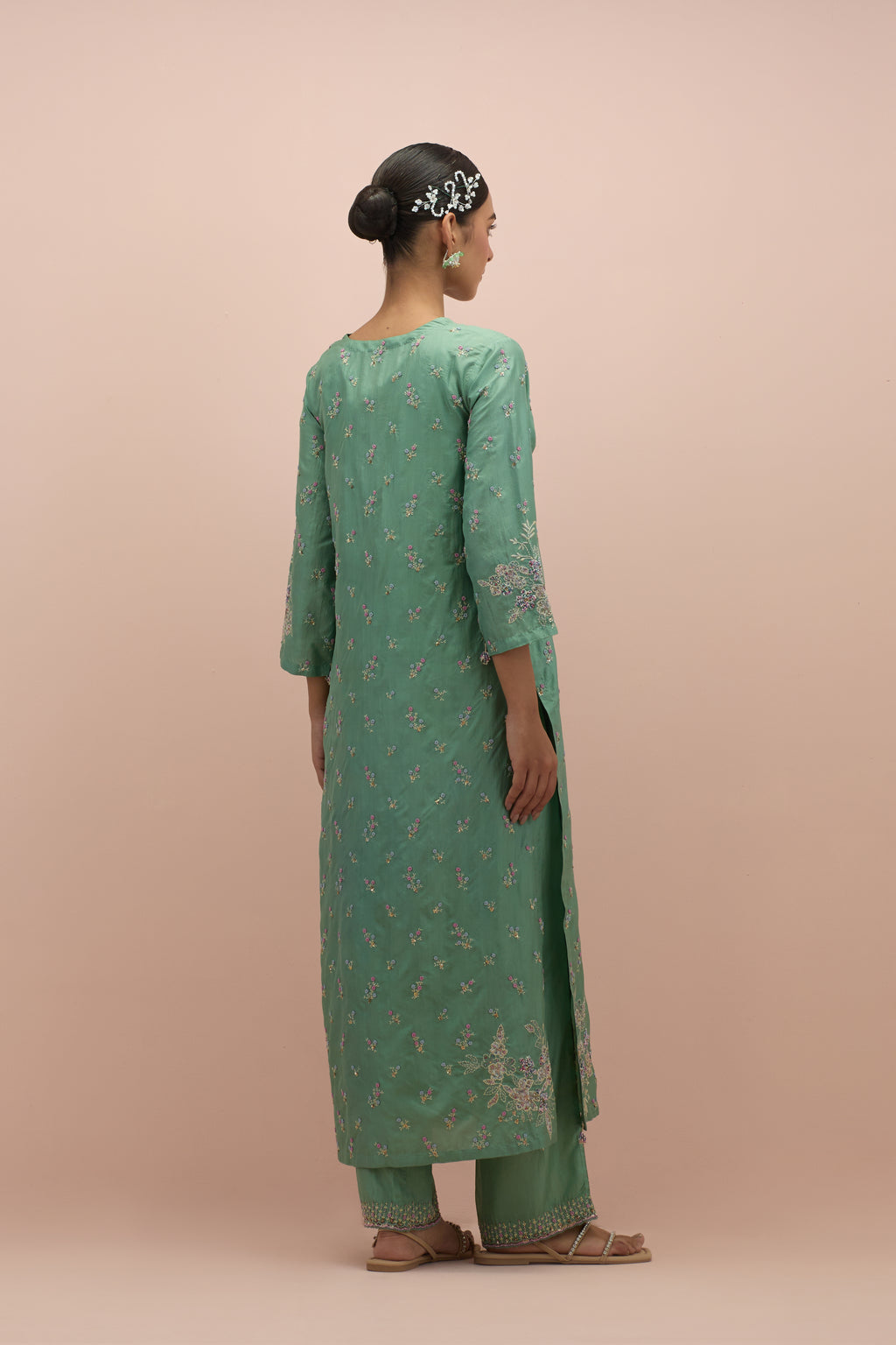Jade green silk straight kurta set with all-over delicate embroidered flowers, highlighted with sequins and multi-colored beads.
