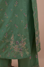 Jade green silk straight kurta set with all-over delicate embroidered flowers, highlighted with sequins and multi-colored beads.