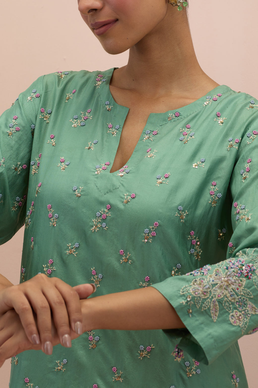 Jade green silk straight kurta set with all-over delicate embroidered flowers, highlighted with sequins and multi-colored beads.