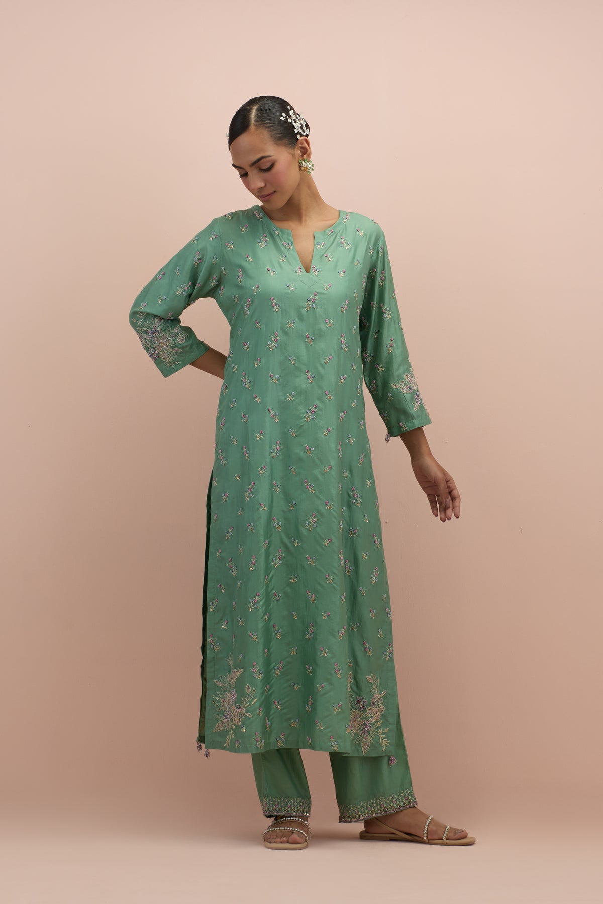 Jade green silk straight kurta set with all-over delicate embroidered flowers, highlighted with sequins and multi-colored beads.