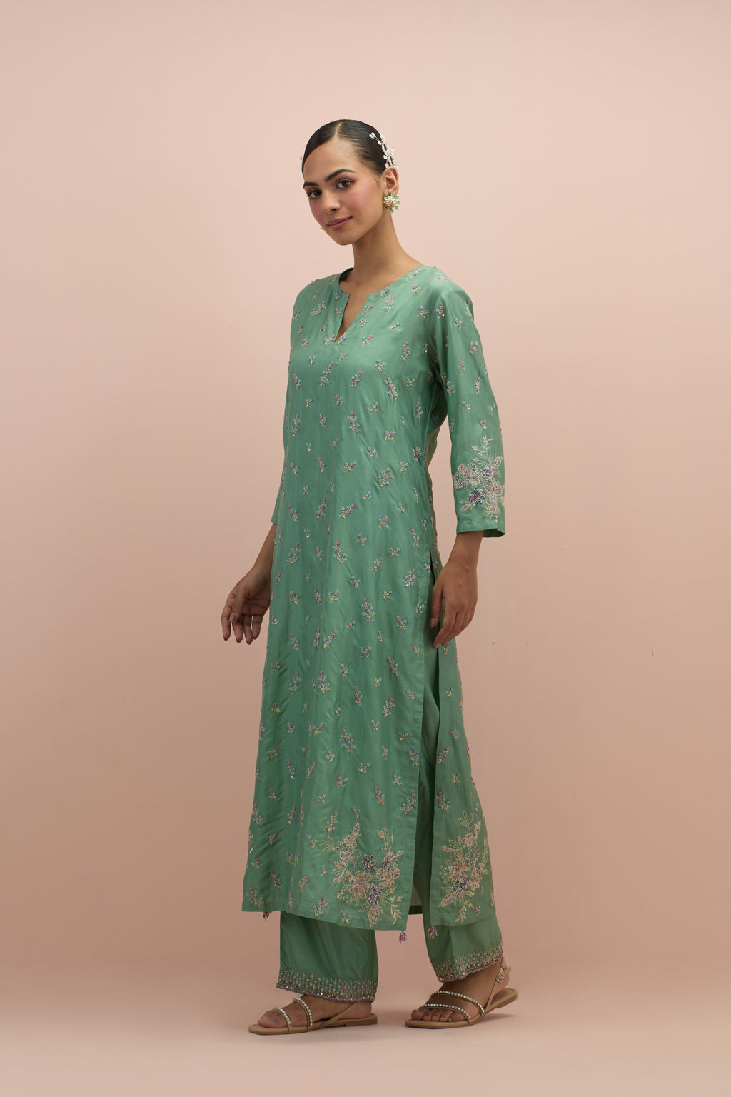 Jade green silk straight kurta set with all-over delicate embroidered flowers, highlighted with sequins and multi-colored beads.