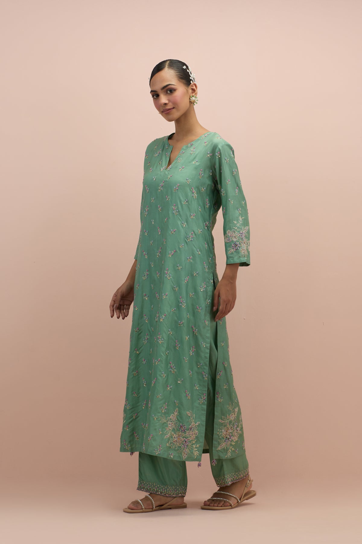 Jade green silk straight kurta set with all-over delicate embroidered flowers, highlighted with sequins and multi-colored beads.