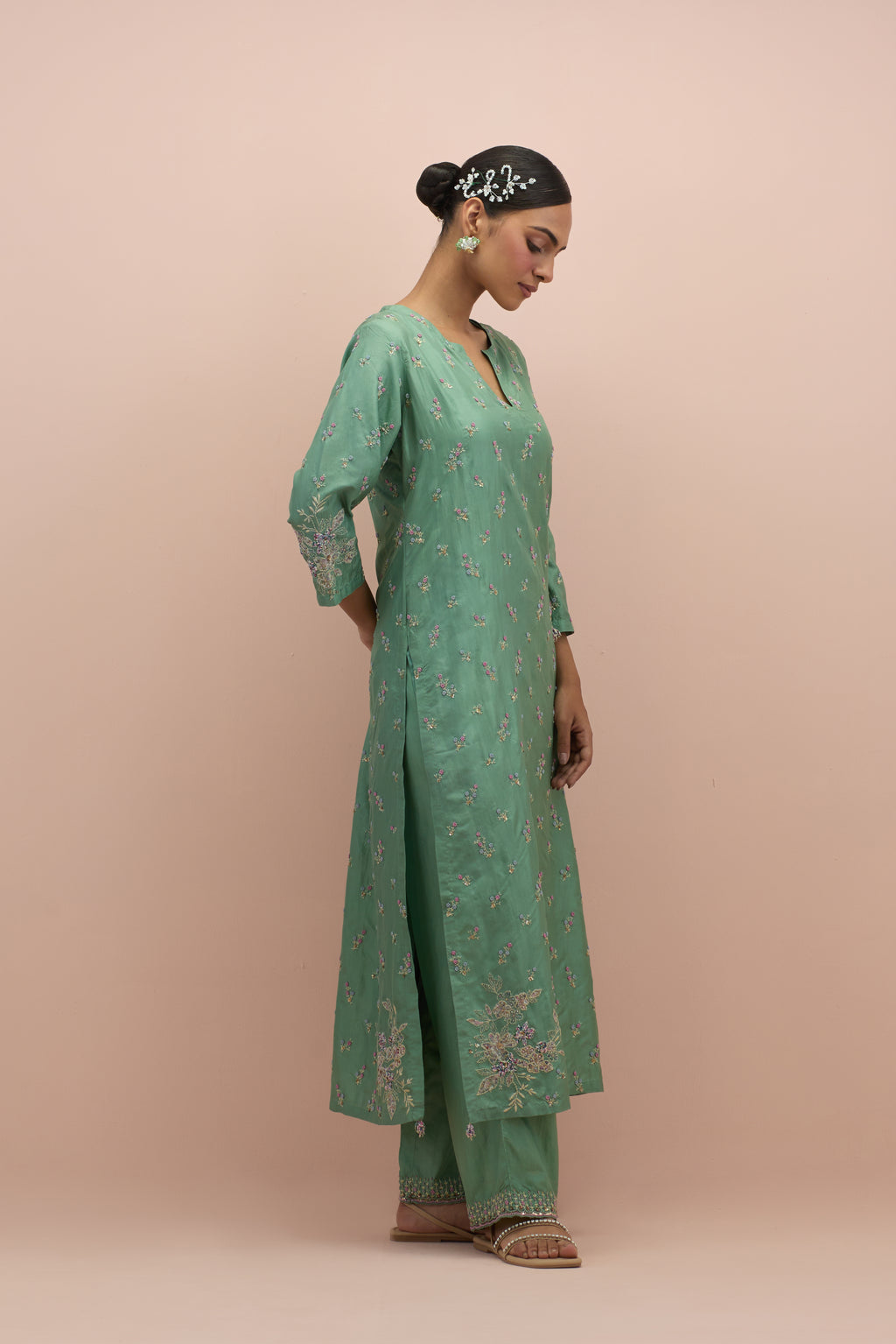 Jade green silk straight kurta set with all-over delicate embroidered flowers, highlighted with sequins and multi-colored beads.