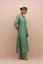 Jade green silk straight kurta set with all-over delicate embroidered flowers, highlighted with sequins and multi-colored beads.