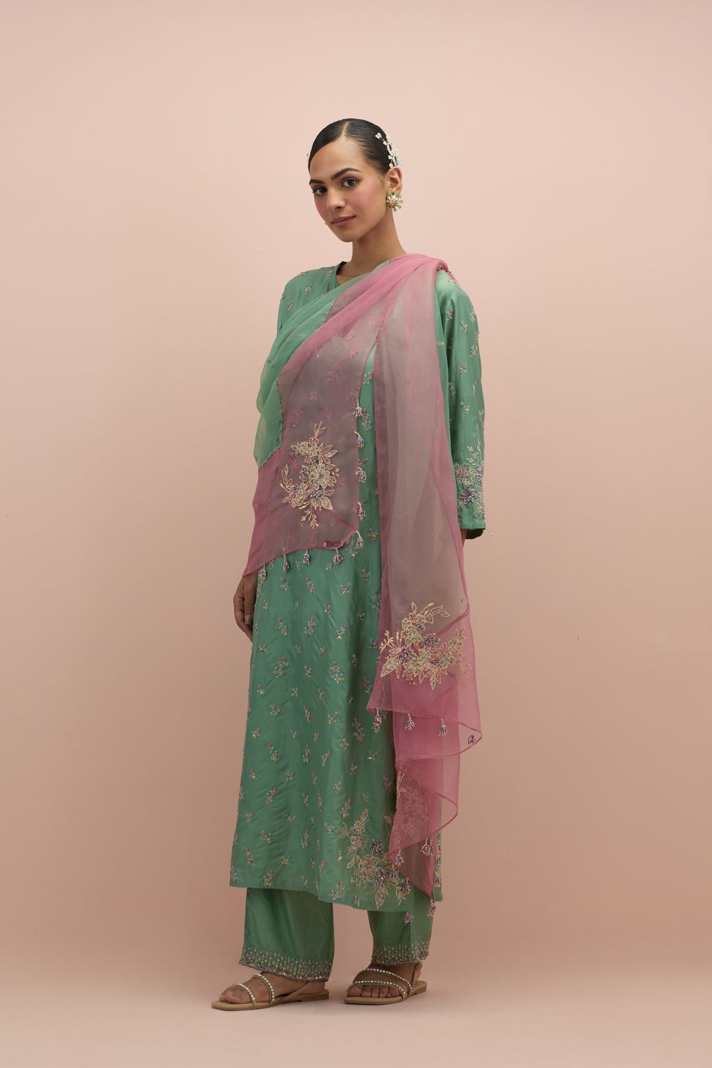 Jade green silk straight kurta set with all-over delicate embroidered flowers, highlighted with sequins and multi-colored beads.
