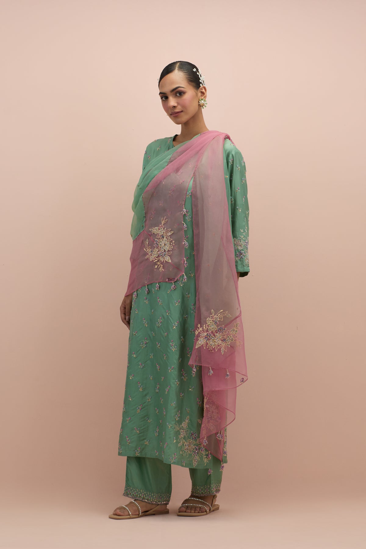 Jade green silk straight kurta set with all-over delicate embroidered flowers, highlighted with sequins and multi-colored beads.