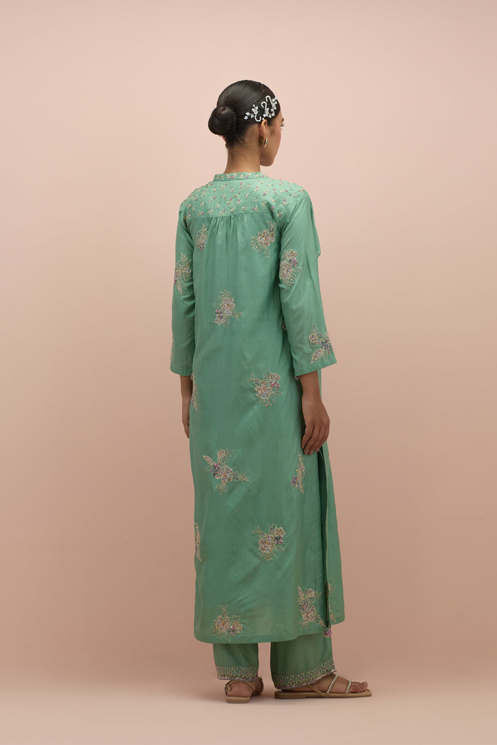 Jade green straight kurta set with all-over delicate embroidered flowers, highlighted with sequins and multi-colored beads.