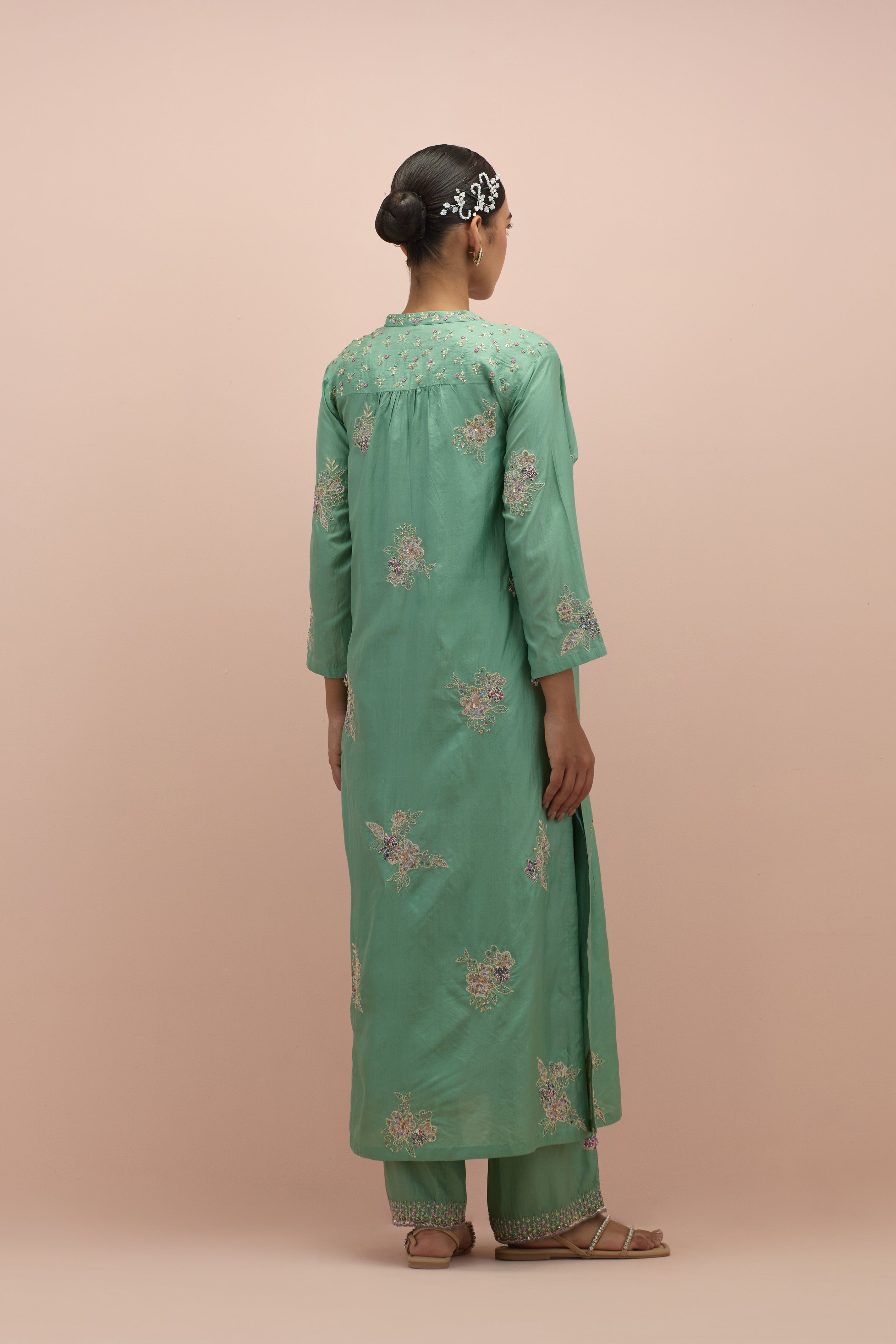 Jade green straight kurta set with all-over delicate embroidered flowers, highlighted with sequins and multi-colored beads.