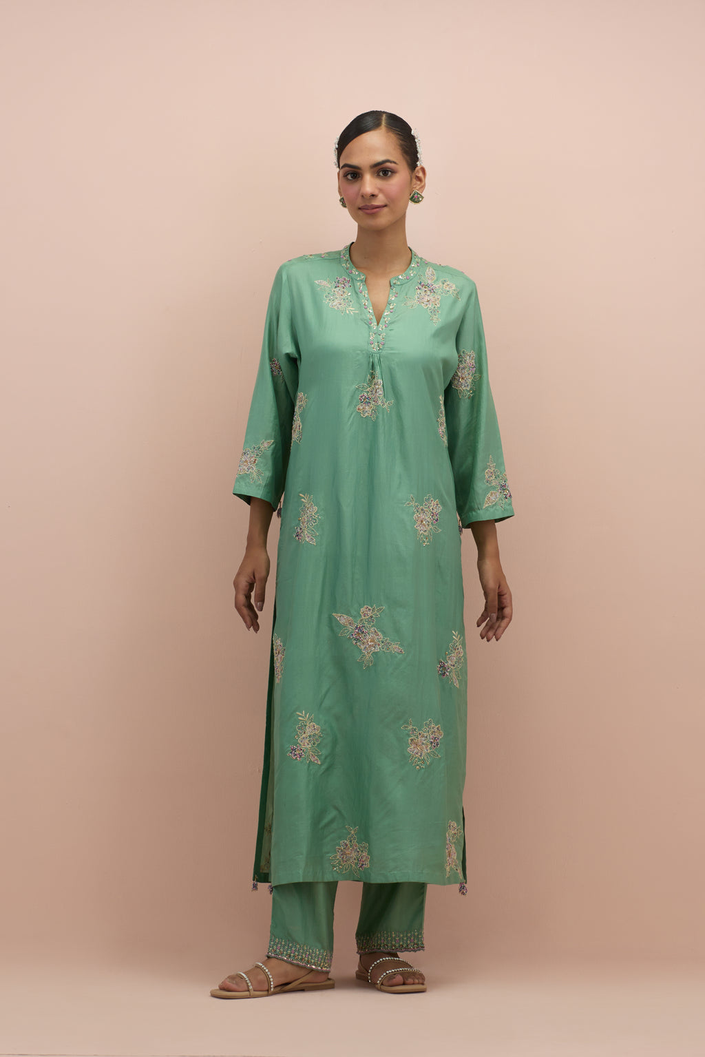 Jade green straight kurta set with all-over delicate embroidered flowers, highlighted with sequins and multi-colored beads.