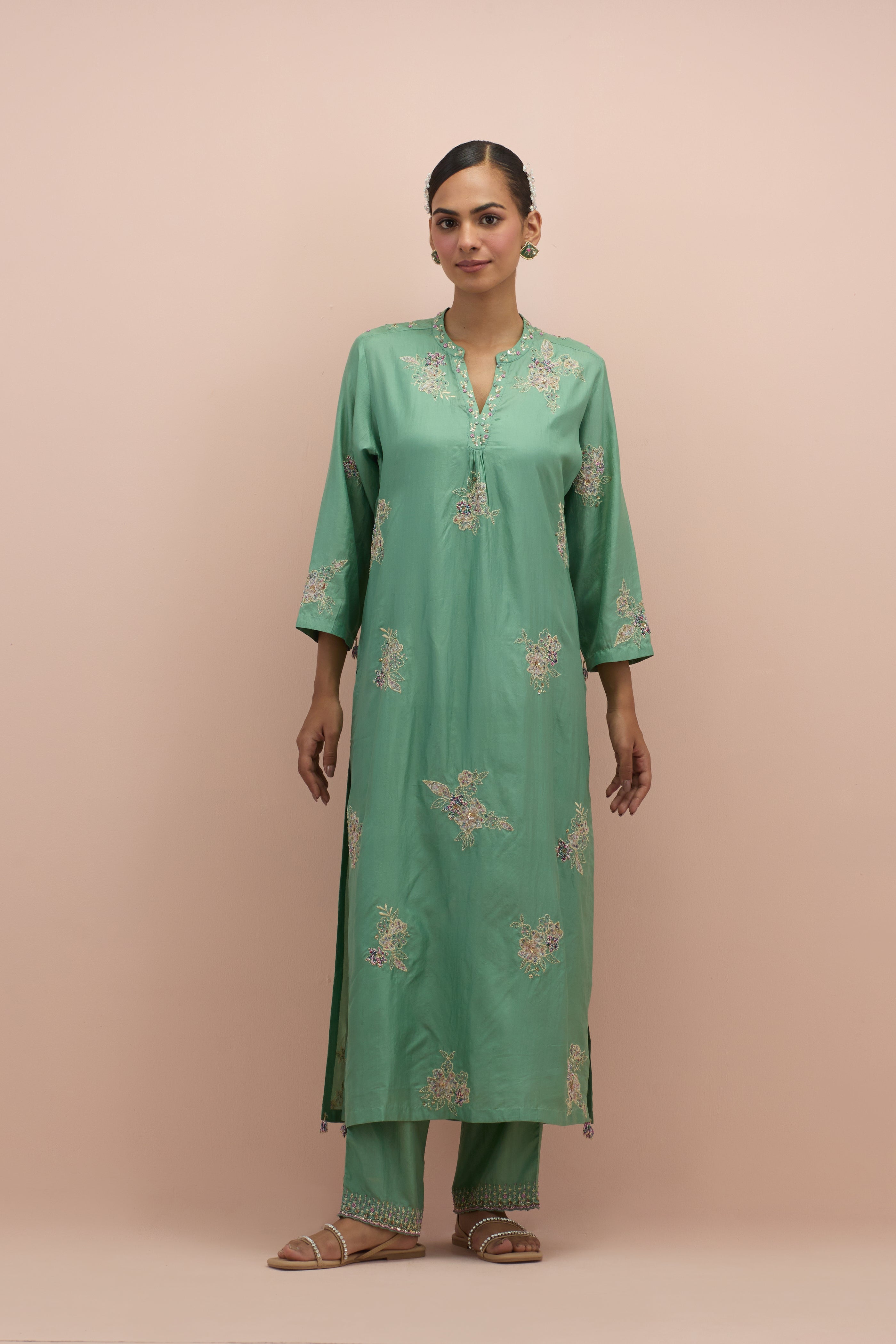 Jade green straight kurta set with all-over delicate embroidered flowers, highlighted with sequins and multi-colored beads.