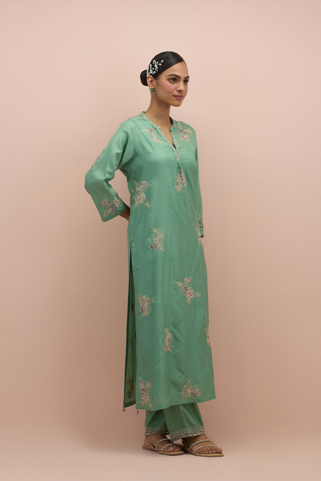 Jade green straight kurta set with all-over delicate embroidered flowers, highlighted with sequins and multi-colored beads.