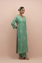 Jade green straight kurta set with all-over delicate embroidered flowers, highlighted with sequins and multi-colored beads.