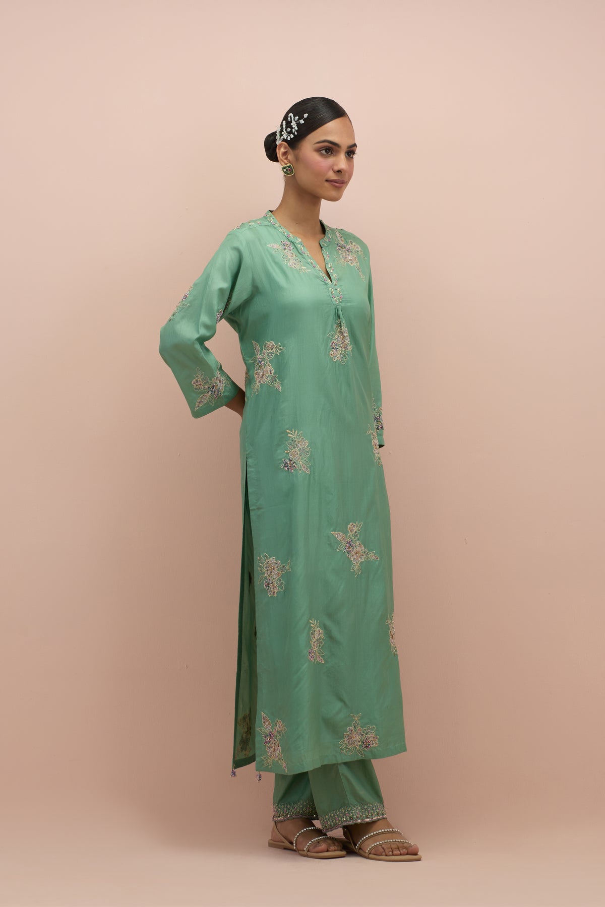 Jade green straight kurta set with all-over delicate embroidered flowers, highlighted with sequins and multi-colored beads.