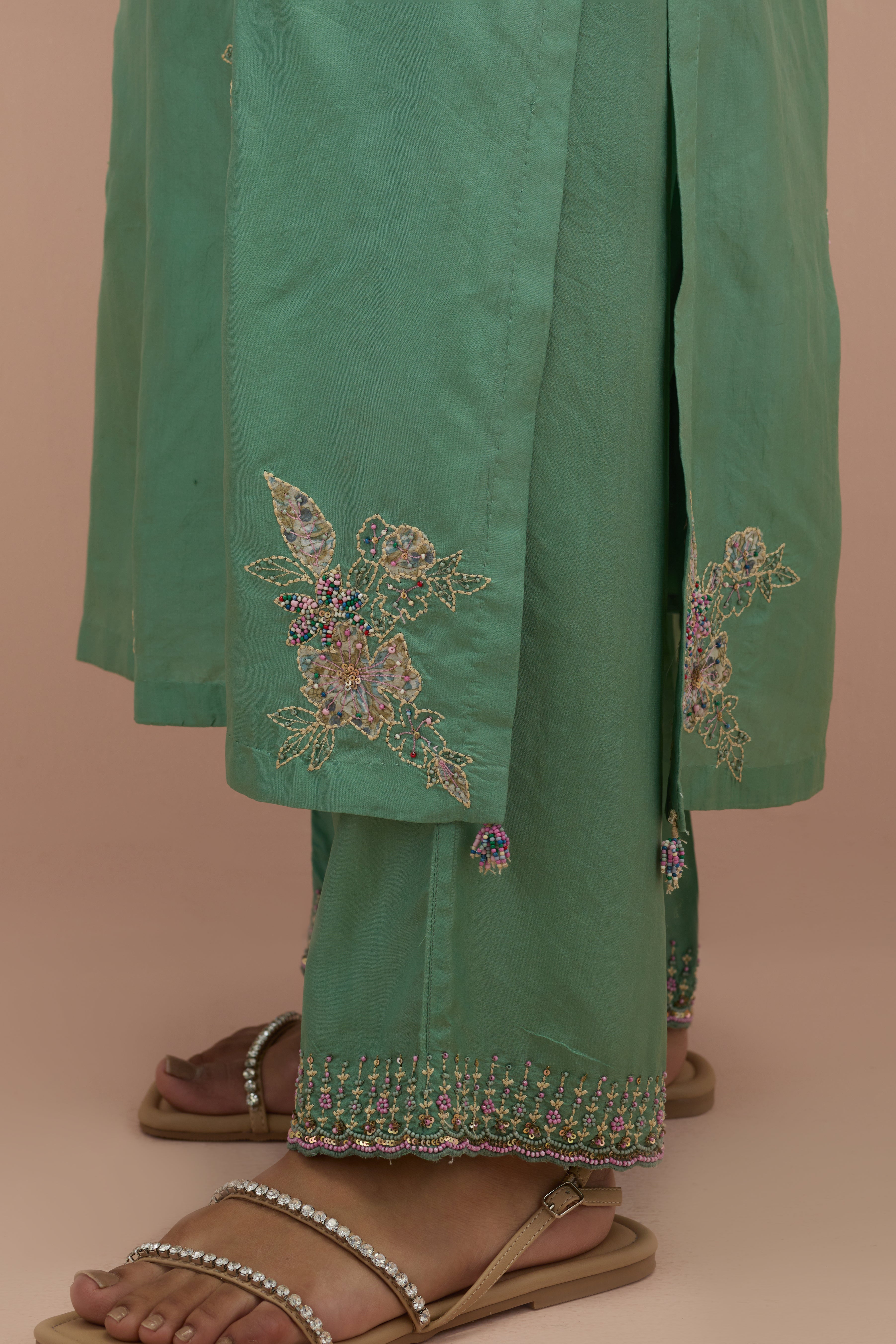 Jade green straight kurta set with all-over delicate embroidered flowers, highlighted with sequins and multi-colored beads.