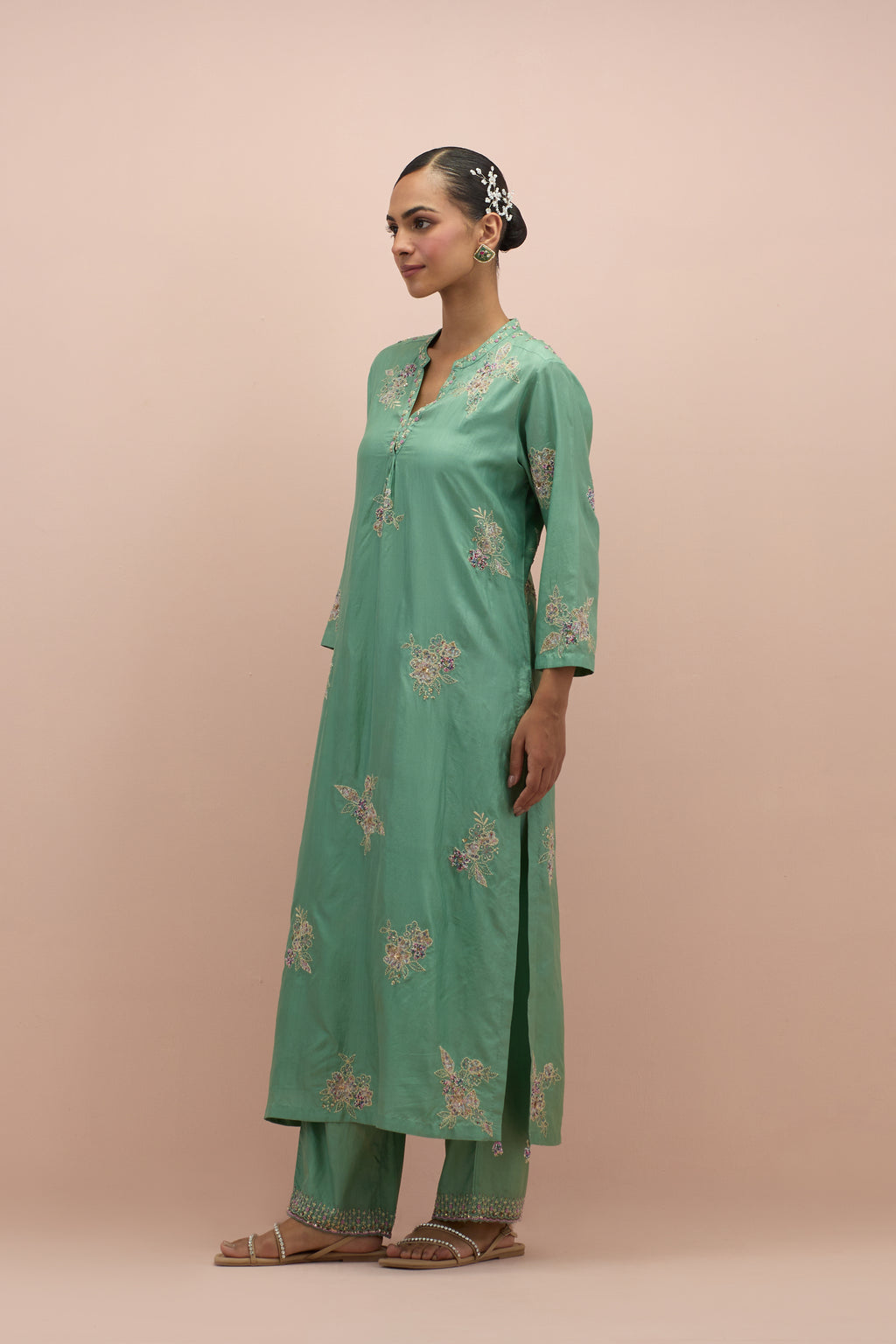 Jade green straight kurta set with all-over delicate embroidered flowers, highlighted with sequins and multi-colored beads.