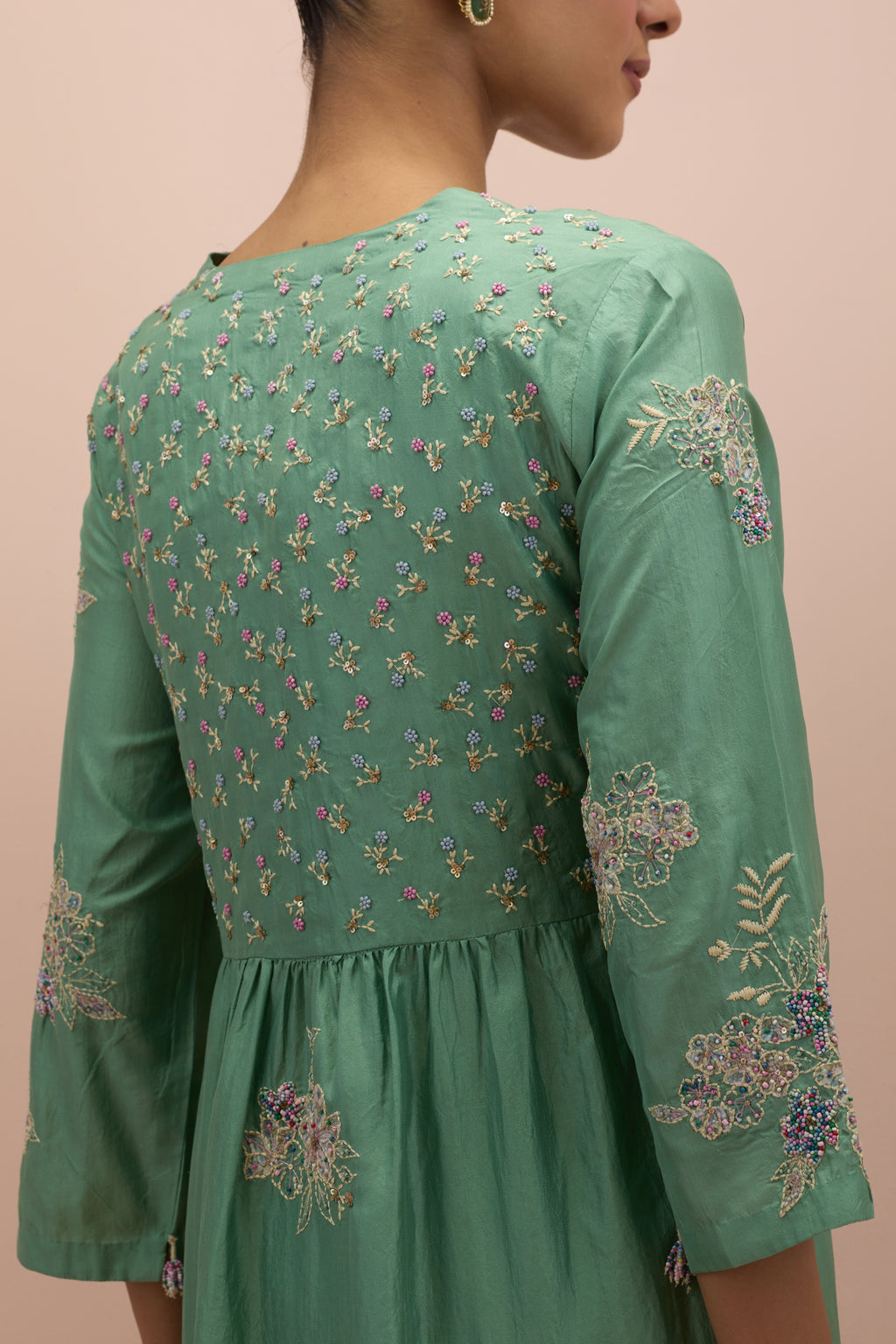 Jade green silk kurta dress set with delicate embroidered flowers and hand block printed appliqué motifs, highlighted with sequins and multi-colored beads.