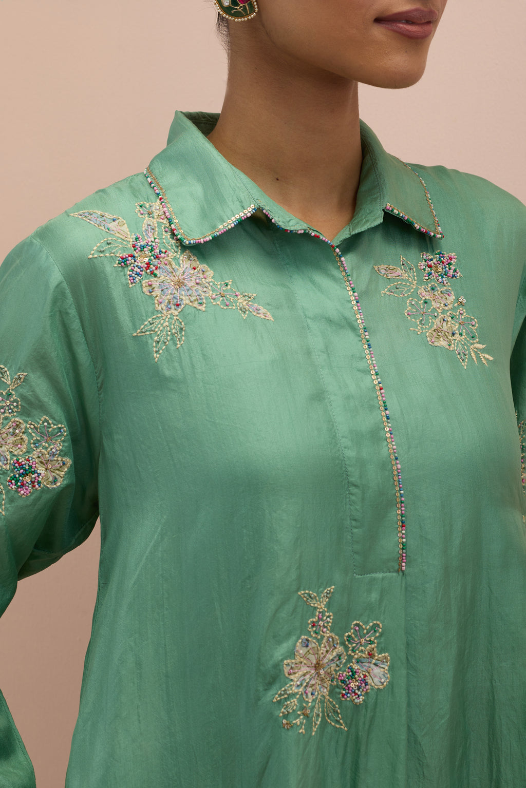 Jade green silk short shirt-kurta set with all-over appliqué flowers, highlighted with sequins and multi-colored beads.