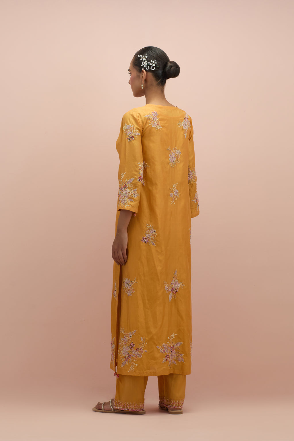 Amber silk straight kurta set with all-over hand block printed appliqué motifs, highlighted with sequins and multi-colored beads.