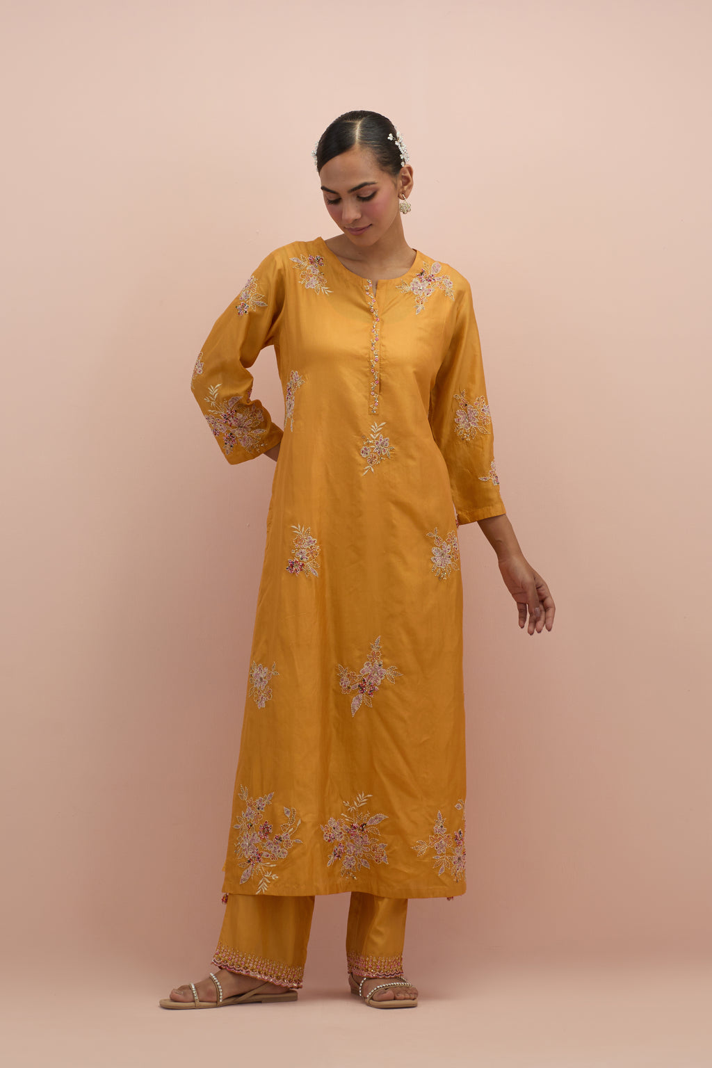 Amber silk straight kurta set with all-over hand block printed appliqué motifs, highlighted with sequins and multi-colored beads.