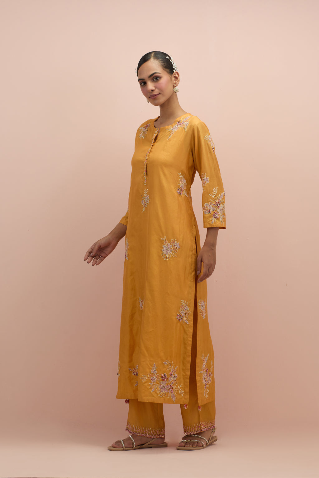 Amber silk straight kurta set with all-over hand block printed appliqué motifs, highlighted with sequins and multi-colored beads.