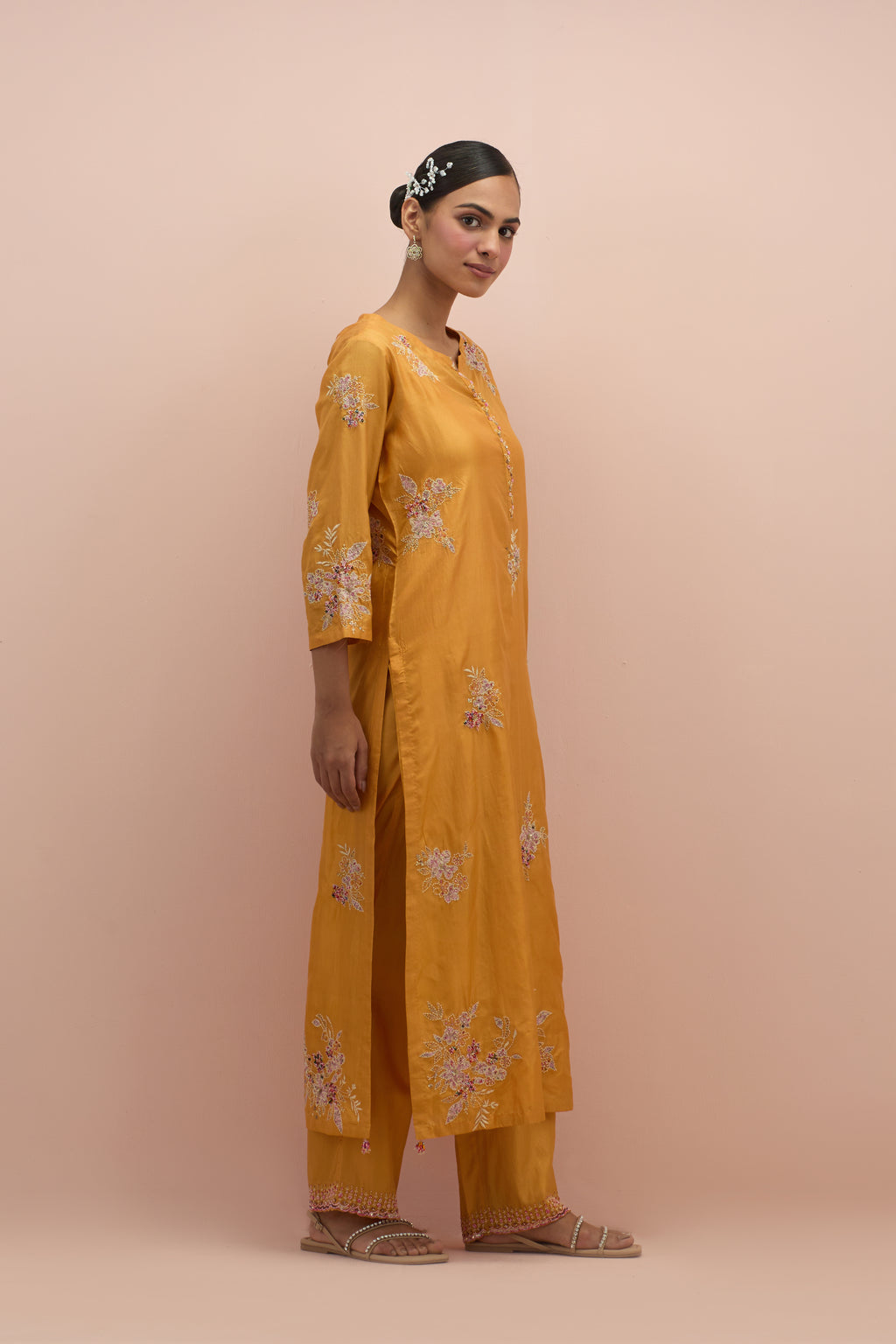 Amber silk straight kurta set with all-over hand block printed appliqué motifs, highlighted with sequins and multi-colored beads.