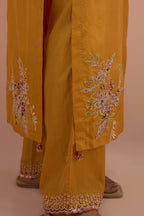 Amber silk straight kurta set with all-over hand block printed appliqué motifs, highlighted with sequins and multi-colored beads.