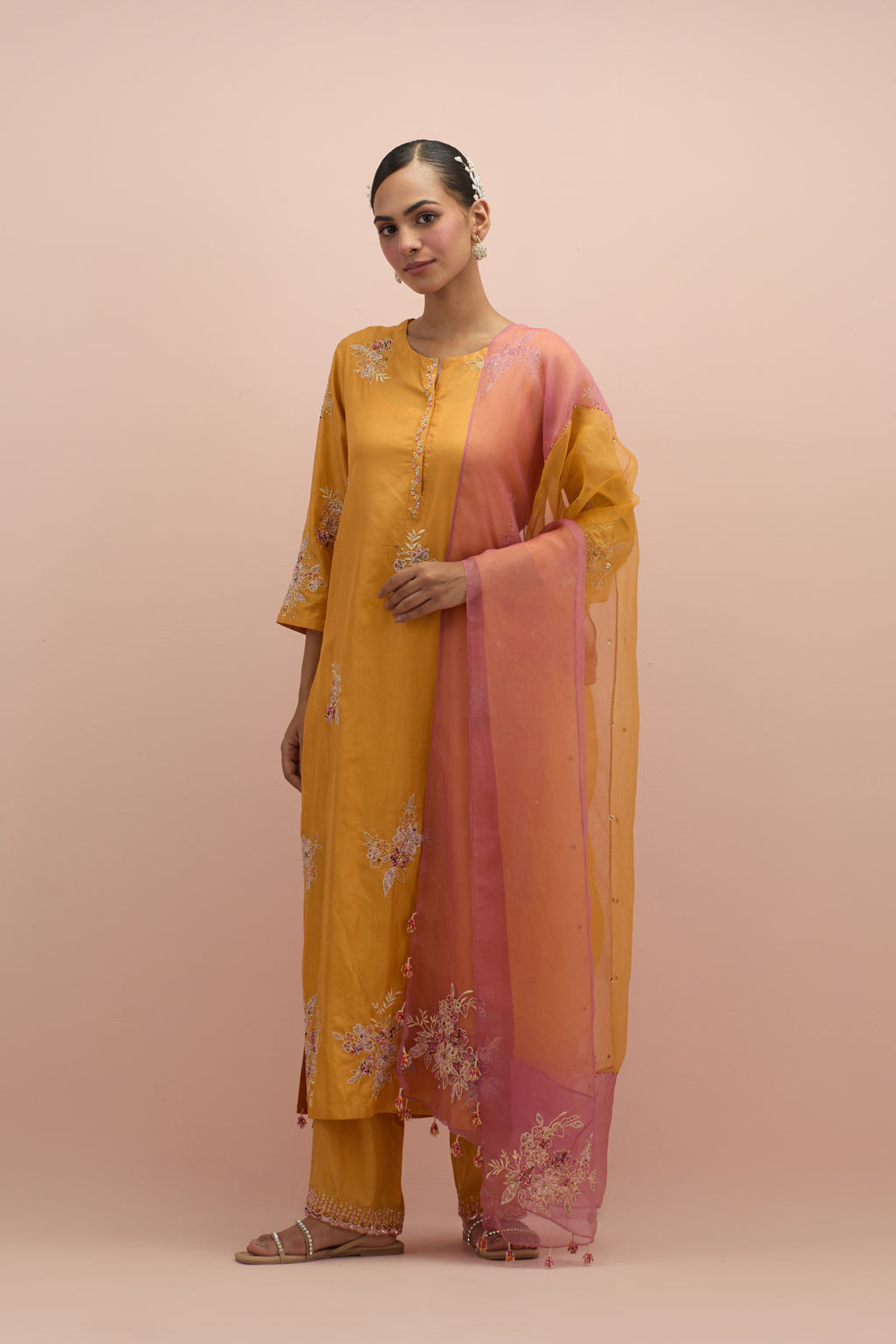 Amber & salmon pink silk organza narrow dupatta, highlighted with all-over delicate sequins flower and hand block printed appliqué motifs at dupatta corners.