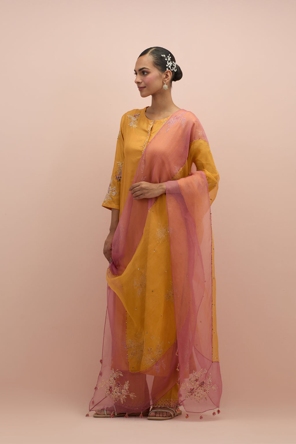 Amber & salmon pink silk organza narrow dupatta, highlighted with all-over delicate sequins flower and hand block printed appliqué motifs at dupatta corners.