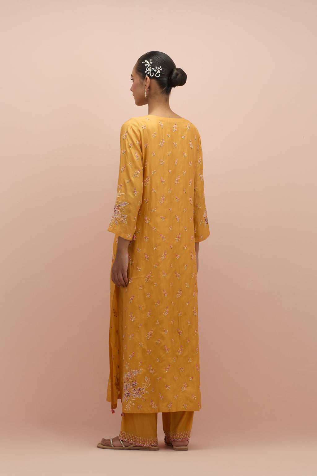 Amber silk straight kurta set with all-over delicate embroidered flowers, highlighted with sequins and multi-colored beads.