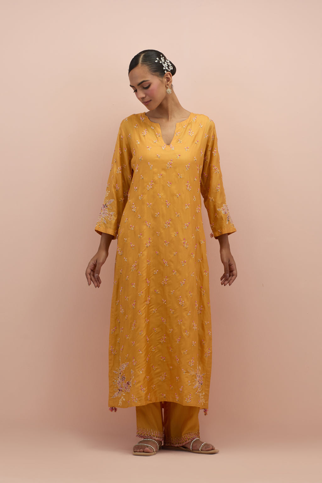 Amber silk straight kurta set with all-over delicate embroidered flowers, highlighted with sequins and multi-colored beads.