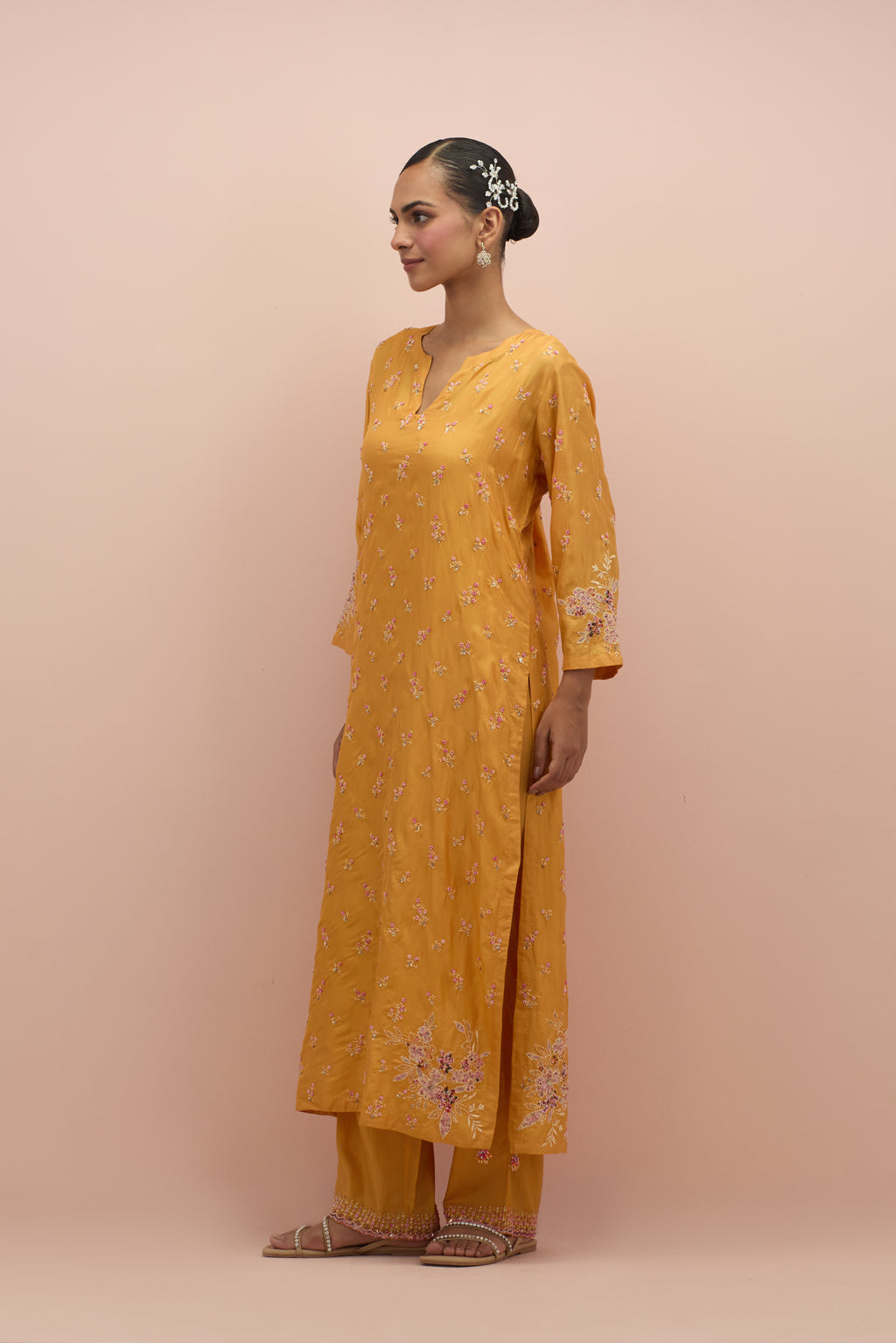 Amber silk straight kurta set with all-over delicate embroidered flowers, highlighted with sequins and multi-colored beads.