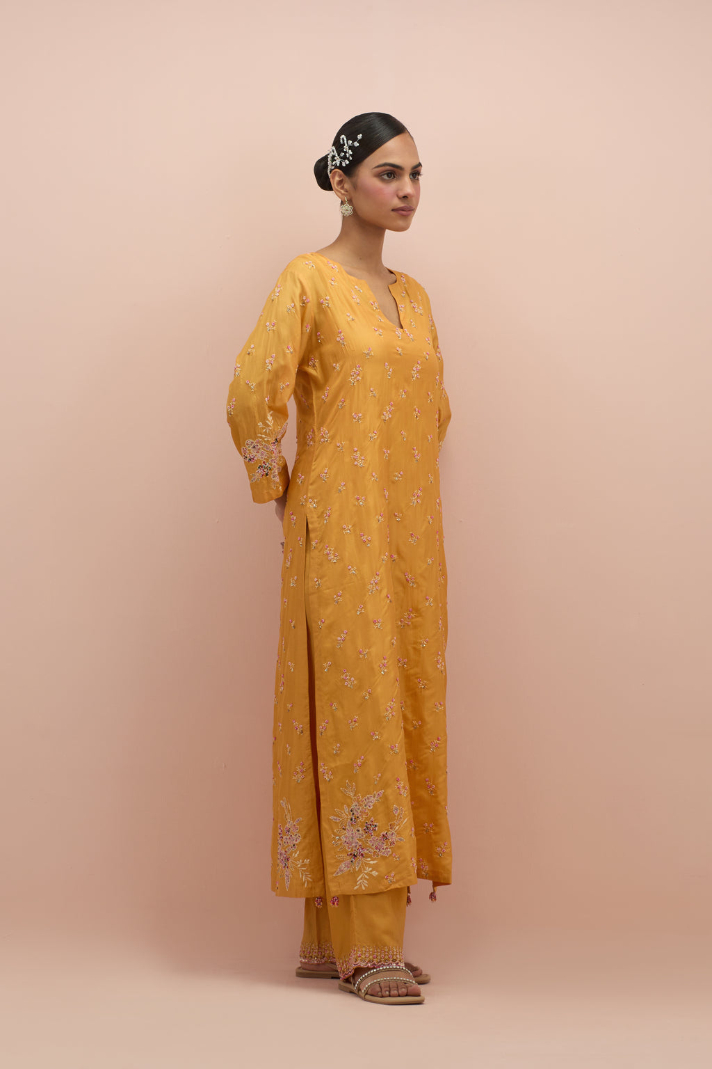 Amber silk straight kurta set with all-over delicate embroidered flowers, highlighted with sequins and multi-colored beads.