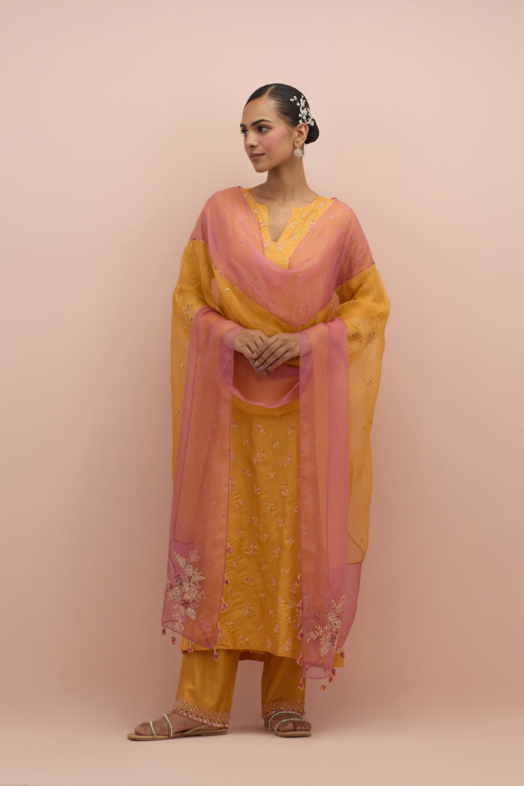 Amber silk straight kurta set with all-over delicate embroidered flowers, highlighted with sequins and multi-colored beads.