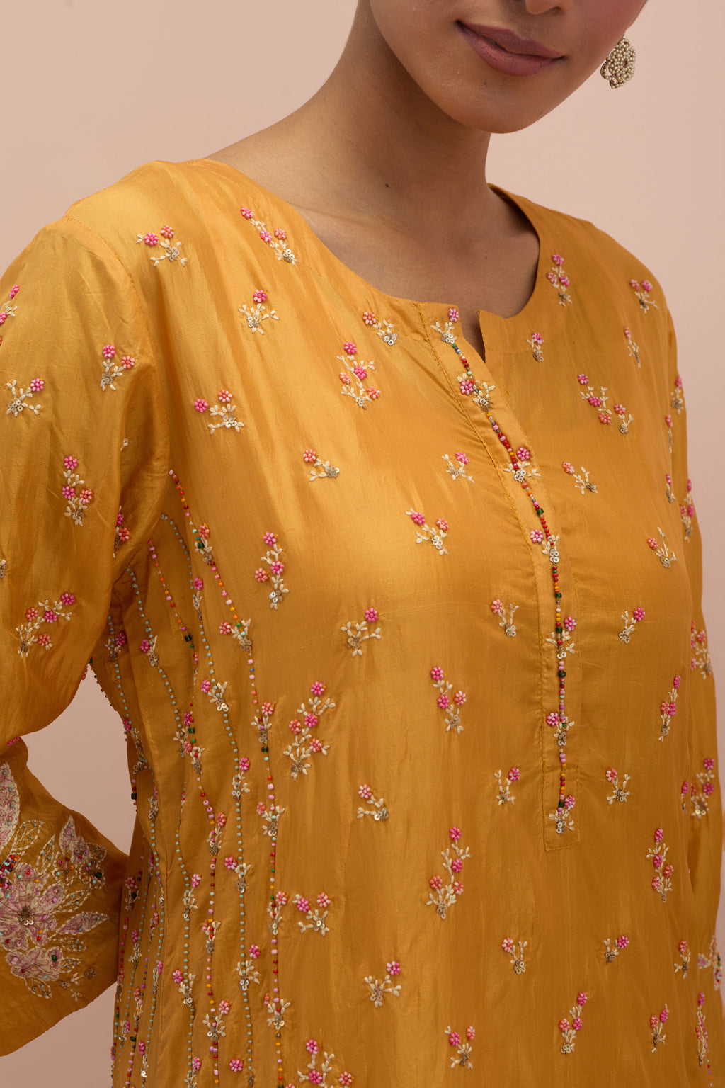 Amber straight kurta set with all-over delicate embroidered flowers, highlighted with sequins and multi-colored beads.